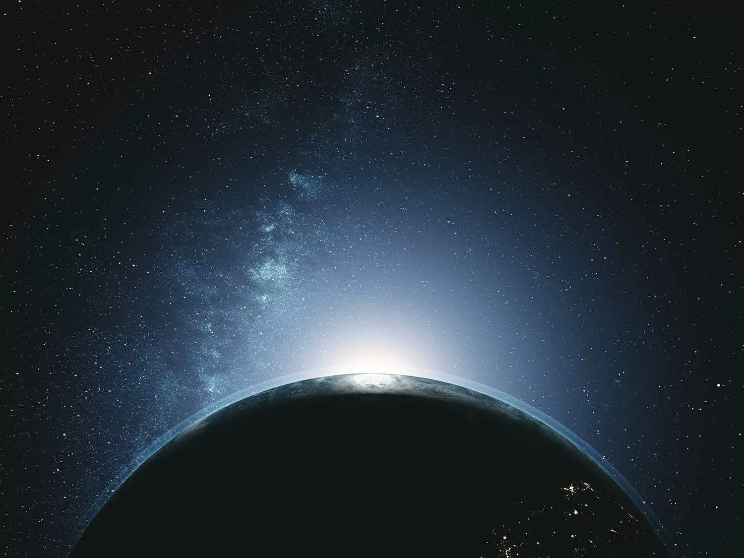 Das Bild zeigt eine beeindruckende Weltraumszene, in der die Erde teilweise im Schatten liegt. Der obere Rand der Erde ist von der Sonne beleuchtet, was einen atemberaubenden Lichteffekt erzeugt, der an einen Sonnenaufgang erinnert. Im Hintergrund ist der Weltraum mit zahlreichen Sternen und einer klar sichtbaren Milchstraße zu sehen. Die Szene vermittelt ein Gefühl von Weite und Erhabenheit und zeigt die Schönheit und das Mysterium des Universums.